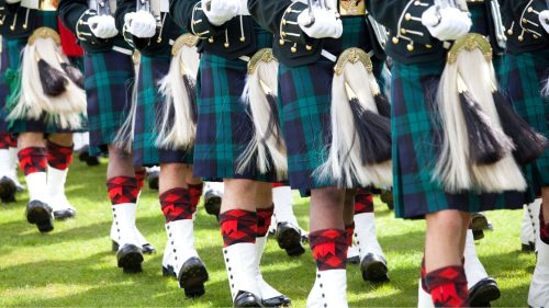 Scottish military band marching on parade. A close up photo of just their kilts.