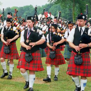 A bagpipe band marching at a Scottish festival.